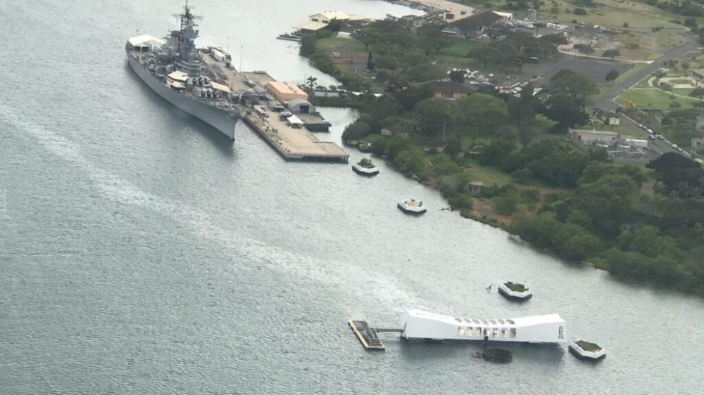 a small boat in a body of water with a city in the background