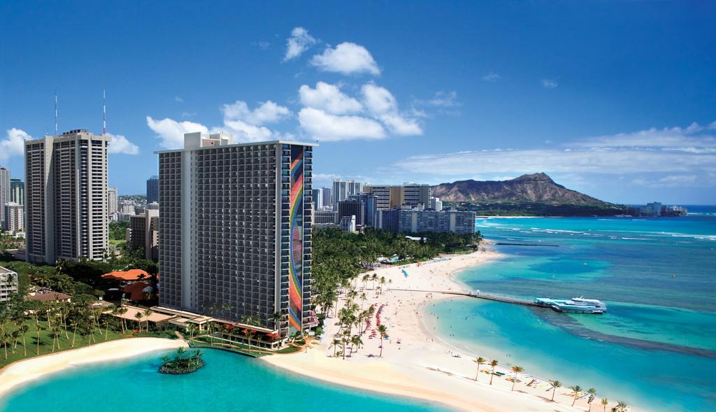 Hawaii Tours a body of water with a city in the background