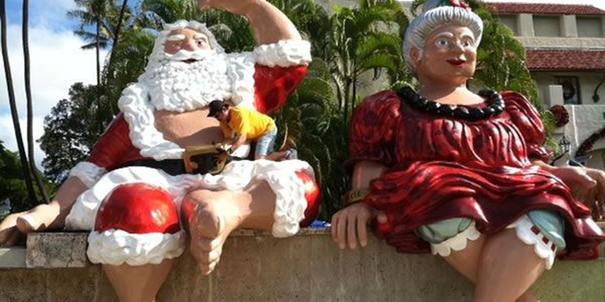 Christmas Holidays in Hawaii a group of stuffed animals sitting on a statue of a person