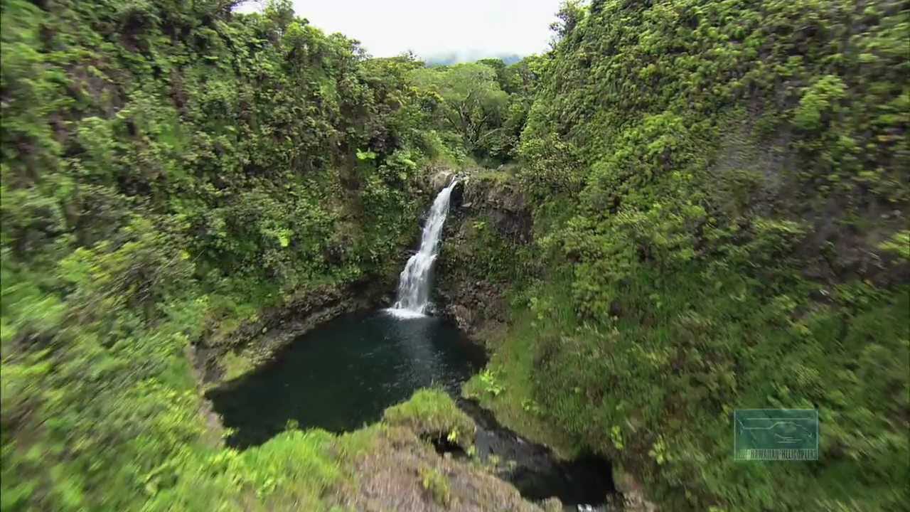 a large waterfall over a body of water a large waterfall over a body of water