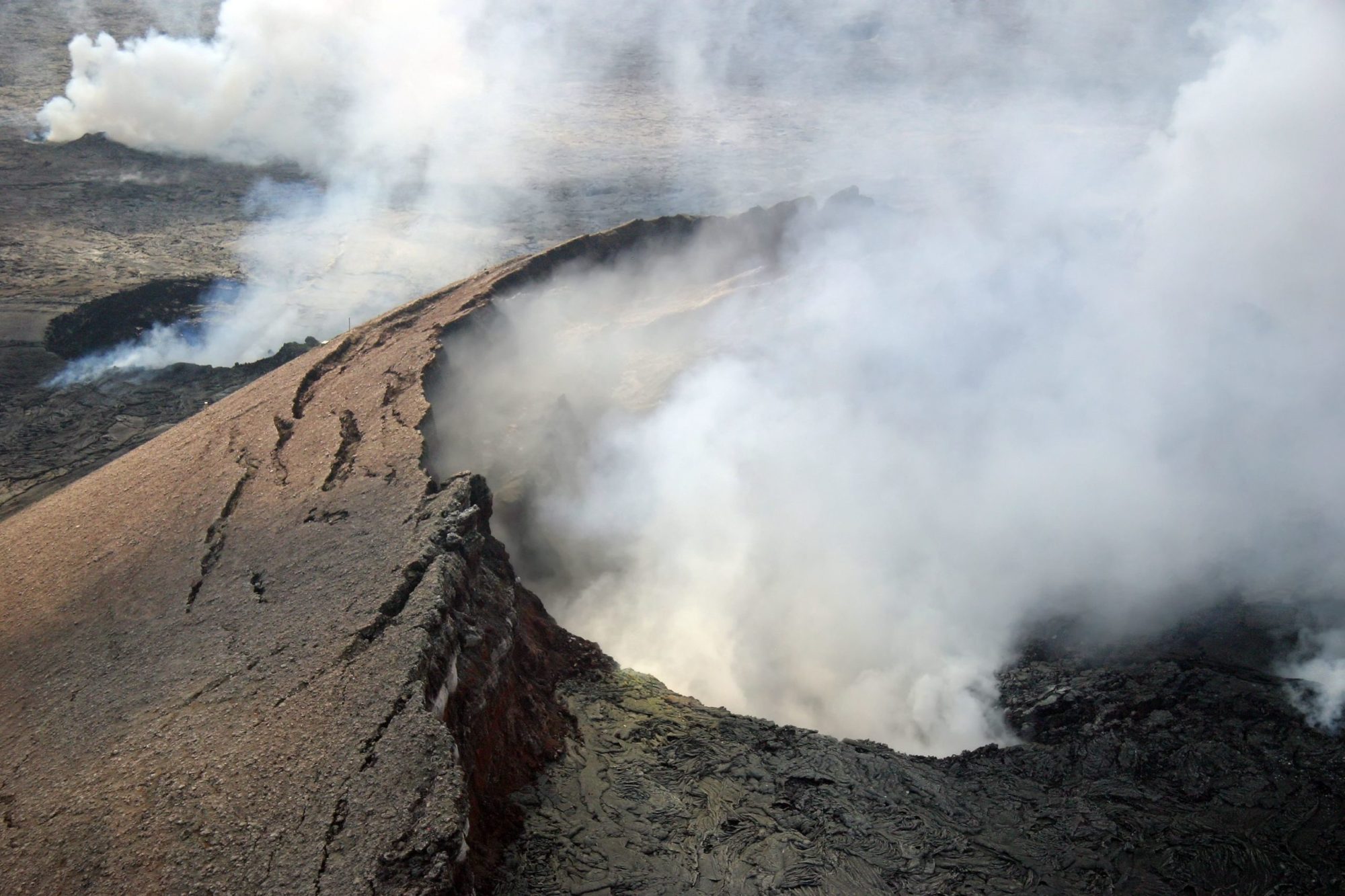 Kilauea crater a train on a track with smoke coming out of it