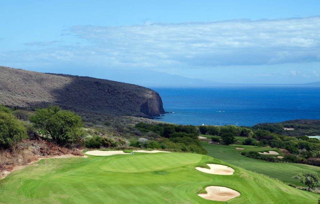 golf-1024×654 a close up of a hillside next to a body of water