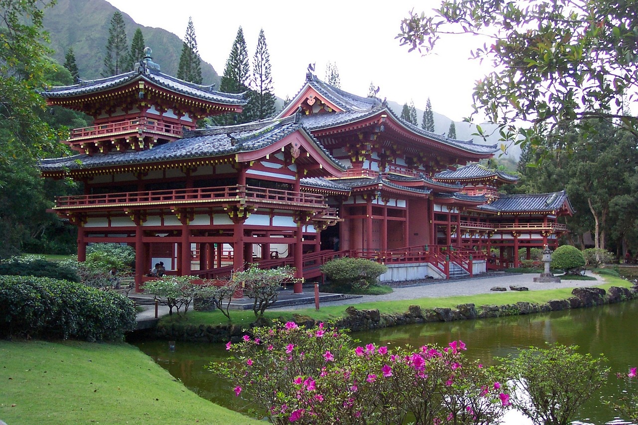 byodo-in-temple-g3e2a67da2_1280 a close up of a flower garden in front of a building