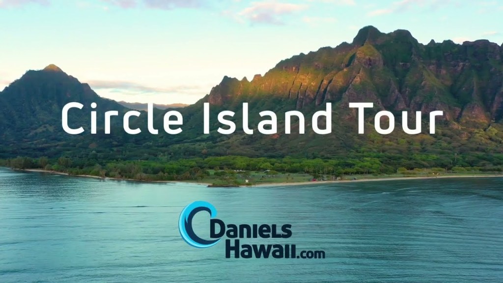 a sign above a body of water with a mountain in the background