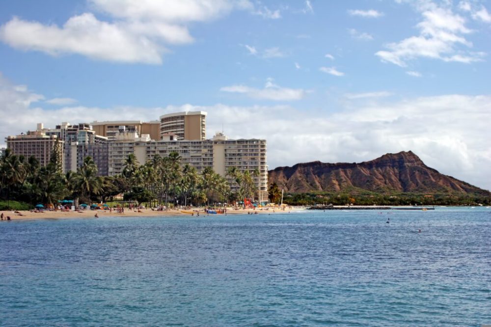 a large body of water with a city in the background