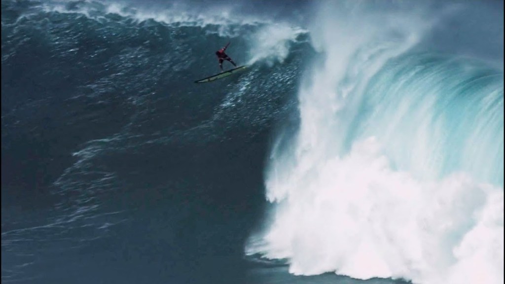 a man riding a wave on a surfboard in the water