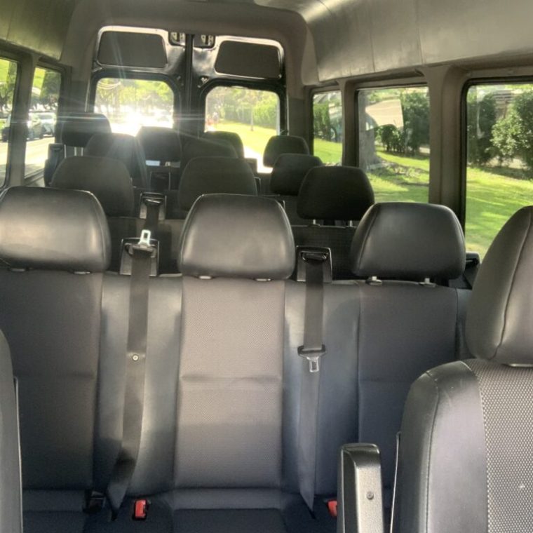 a passenger bus that is sitting on the seat of a car
