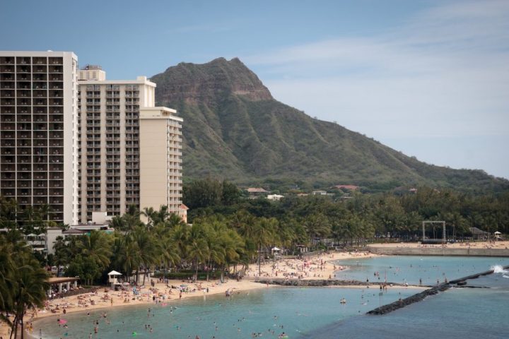 a large body of water with a mountain in the background