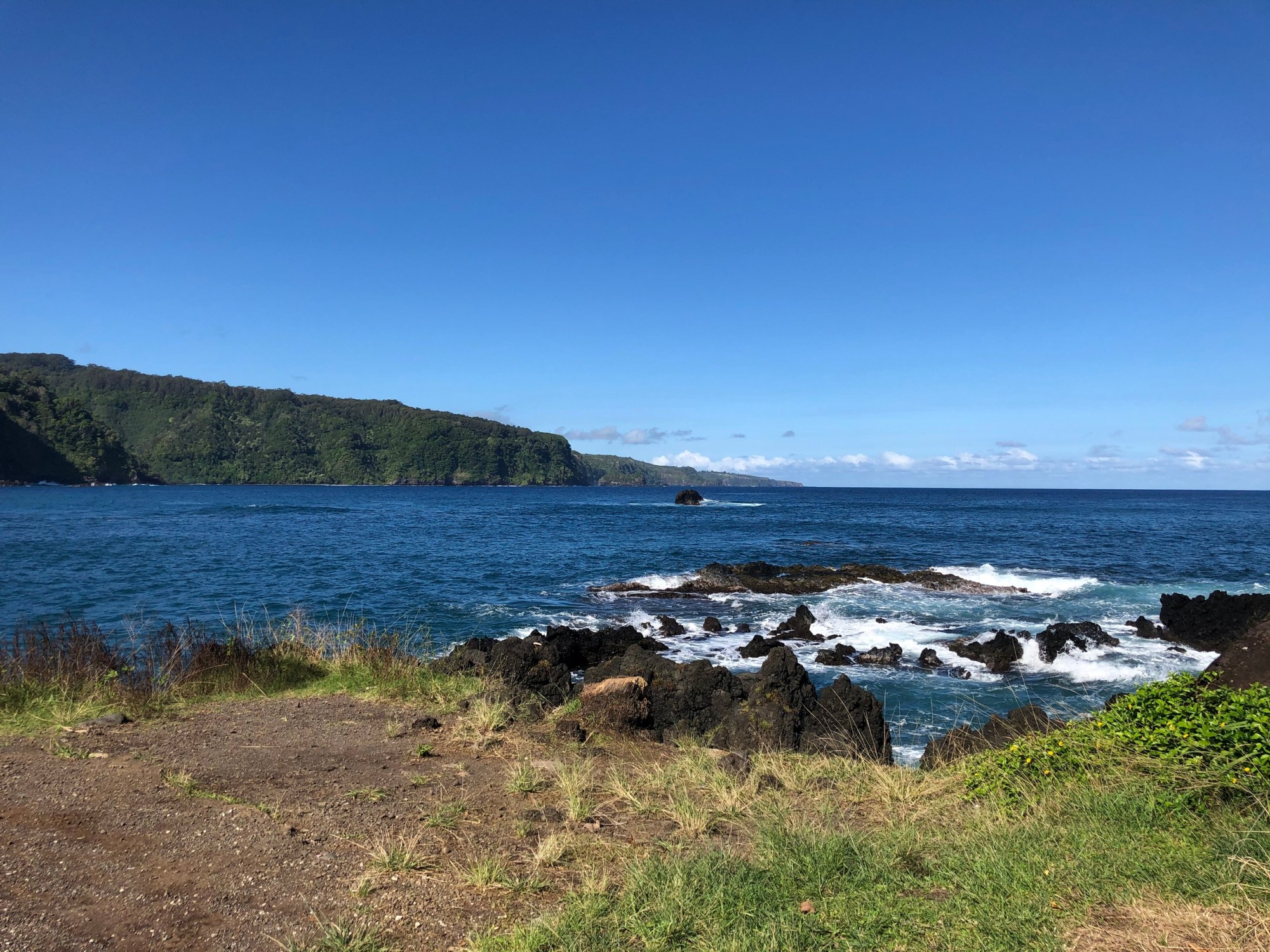 Luxury Full-Circle Road to Hana Tour – Shared Image 6 a rocky shore next to a body of water