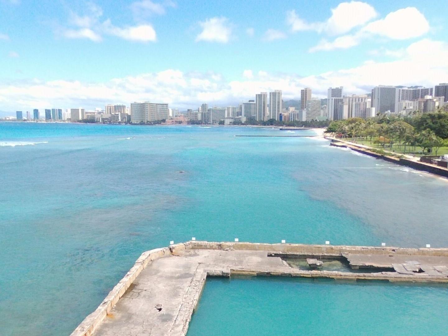 a large body of water with a city in the background