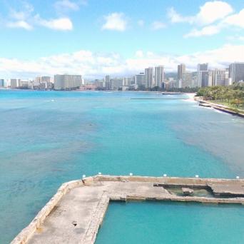 a large body of water with a city in the background