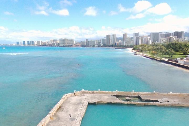 a large body of water with a city in the background