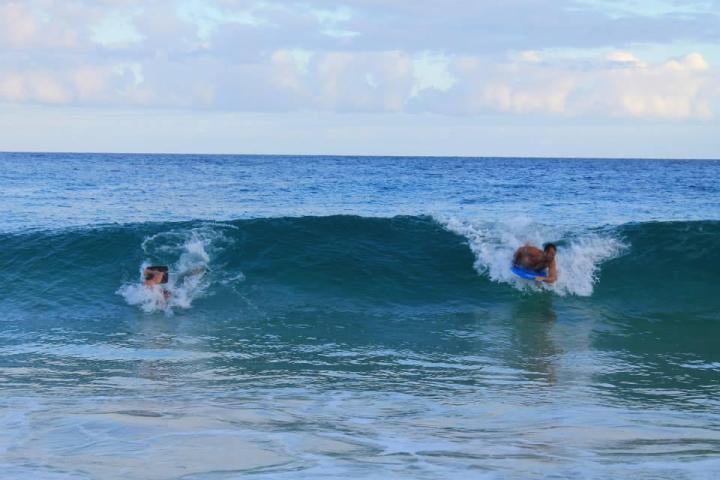 a man riding a wave on a surfboard in the ocean