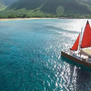 a small boat in a body of water with a mountain in the background
