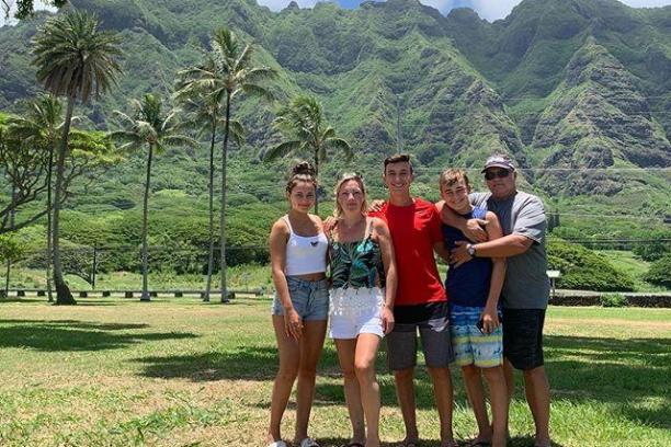 a group of people standing in front of a mountain
