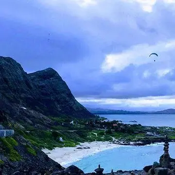 a large body of water with a mountain in the background