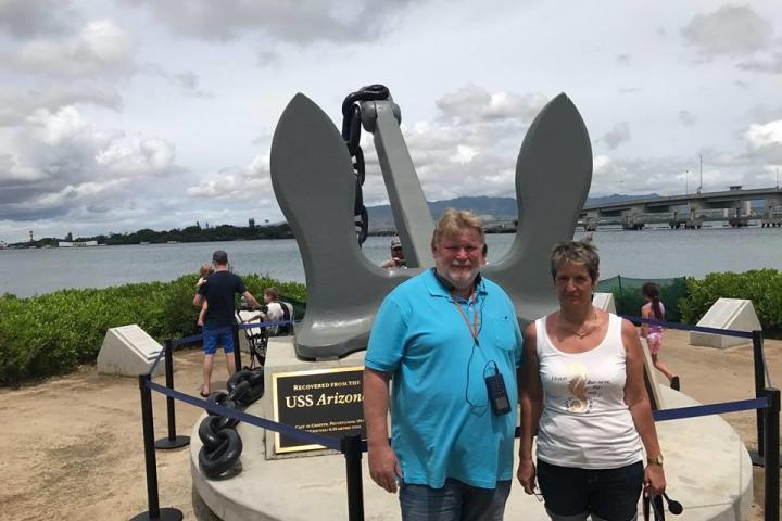 a group of people standing in front of a body of water