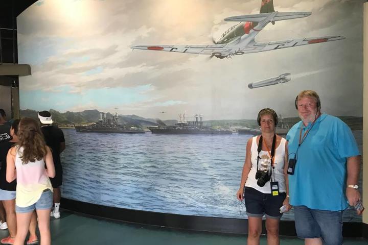a group of people standing next to a body of water