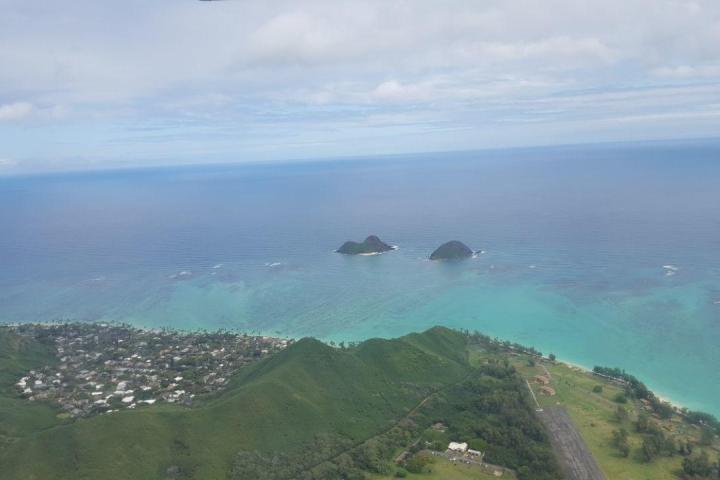 a large body of water with a mountain in the background