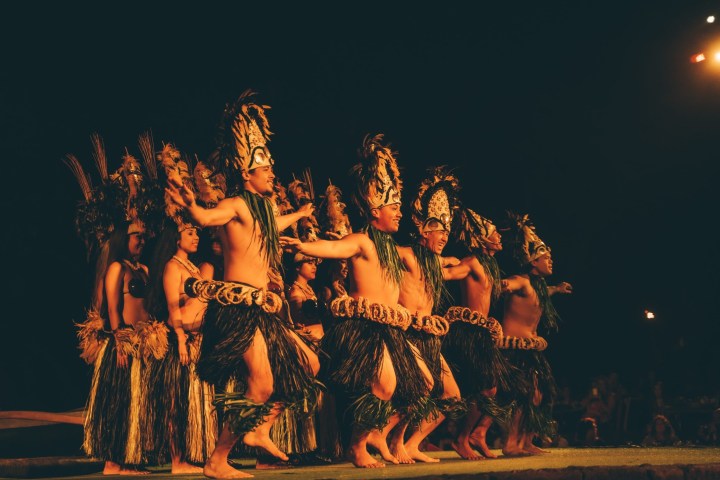 a group of people that are standing in the dark