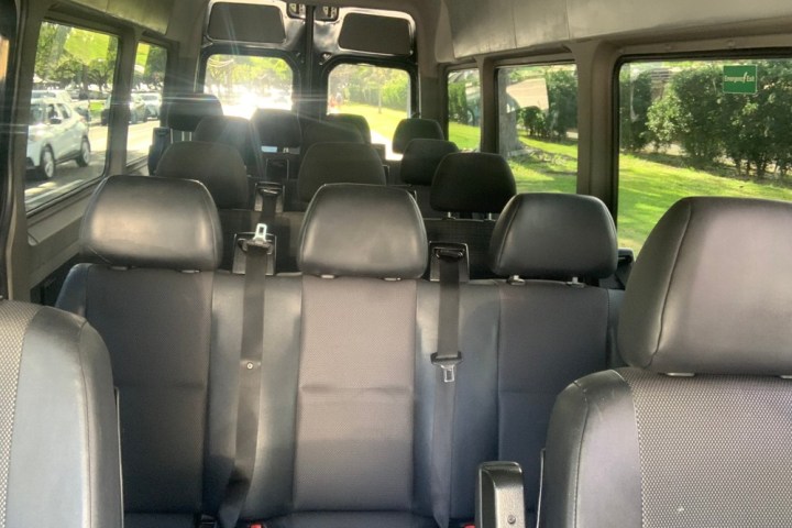 a passenger bus that is sitting on the seat of a car