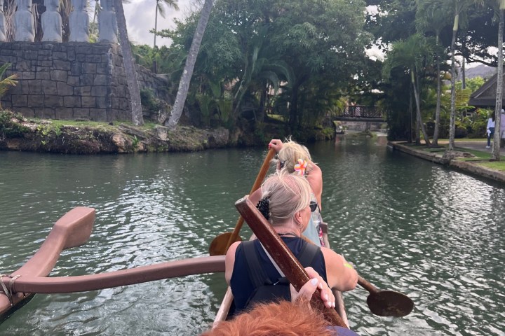 a person riding on the back of a boat in the water