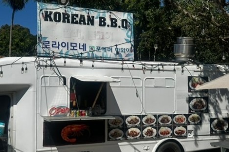 a truck is parked in front of a sign