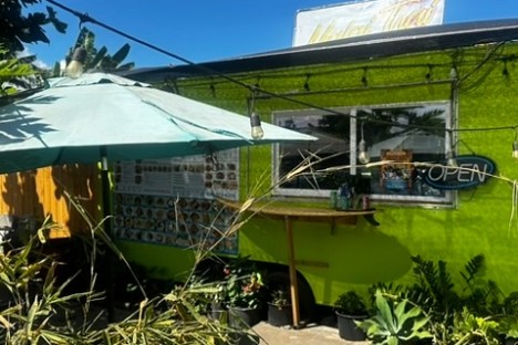 a boat sitting on top of a green field