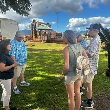 a couple of people that are standing in the grass