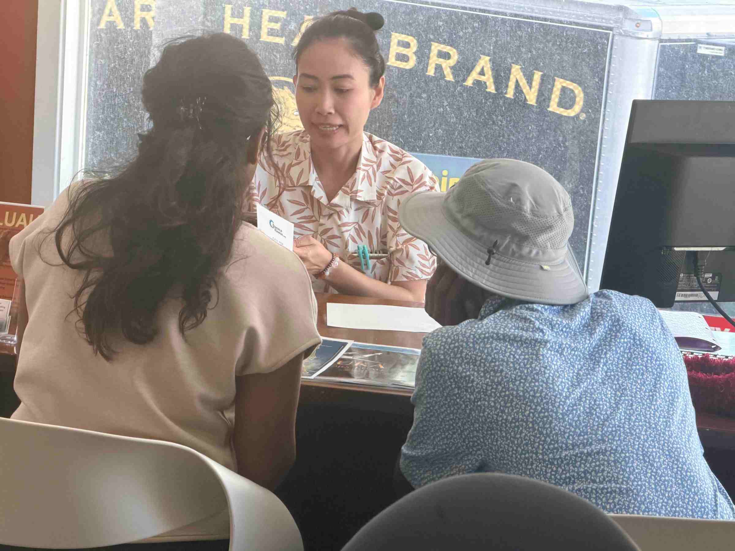 Three people seated at a table, engaged in a discussion.
